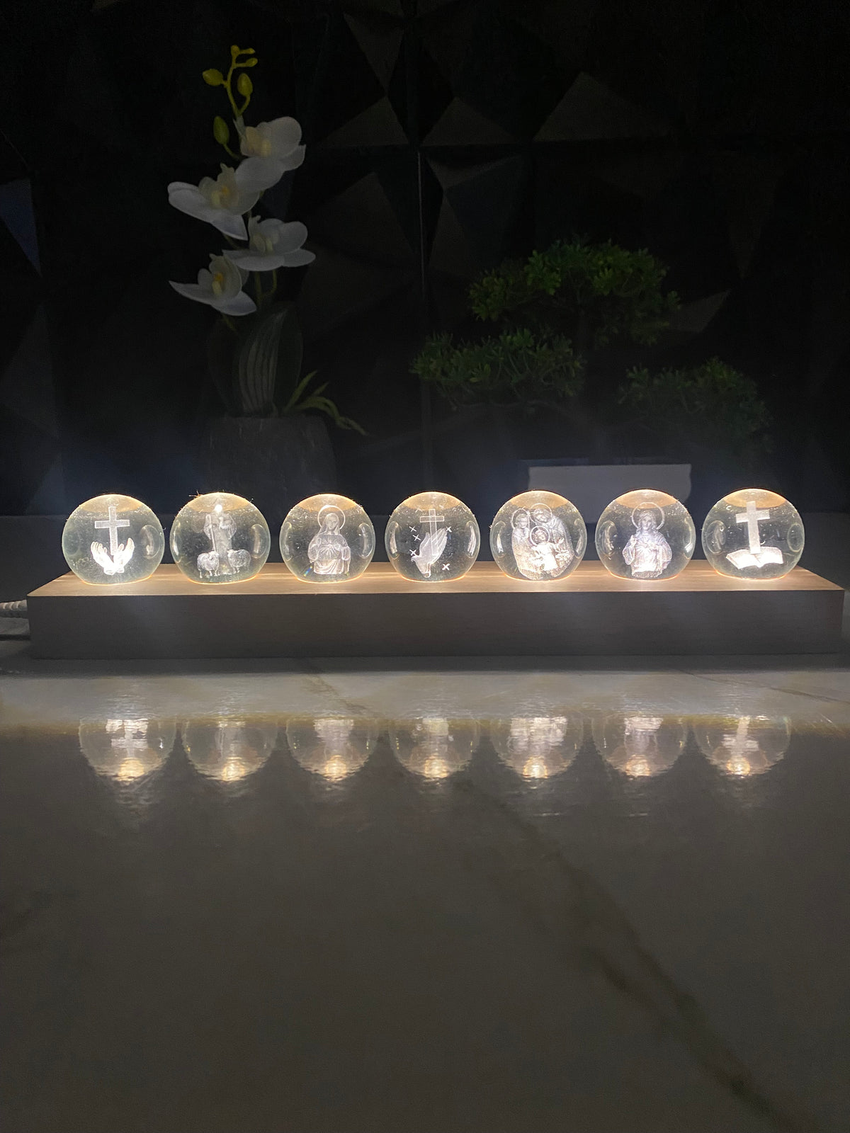 Seven illuminated religious crystal spheres glowing at night
